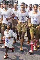 Child marathon runner Buddhia Singh leading a bunch of CRPF jawans in Puri on Tuesday