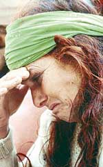 A relative of the recent Doda massacre victims at Tawa village in Jammu and Kashmir breaks into tears during the Defence Minister's visit to the area on Tuesday.