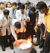 Agitating senior residents of the PGI tear their termination notices before consigning them to fire at the PGIs upper caf on Friday.