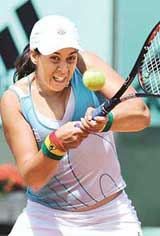 France�s Marion Bartoli returns a shot to compatriot Aurelie Verdy during their match at the French Open in Paris on Sunday