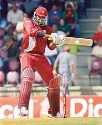Chris Gayle of the West Indies hits a boundary during the fifth one-day against India in Port of Spain on Sunday