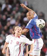 Thierry Henry of France vies for the ball with Denmark�s Christian Poulsen during a friendly at the Bollaert stadium in Lens on Wednesday