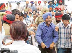 Protesting unemployed veterinary pharmacists being pushed out of the venue for the inaugural function of Guru Angad Dev Veterinary and Animal Sciences University in Ludhiana on Friday. 