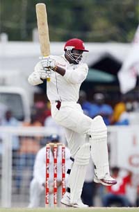 Chris Gayle of the West Indies hits a shot on the second day of the first test cricket match against India in St. John's