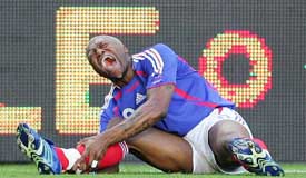 Djibril Cisse of France cries out in pain after being tackled by China�s Zheng Zhi during a friendly match in St Etienne, France, on Wednesday