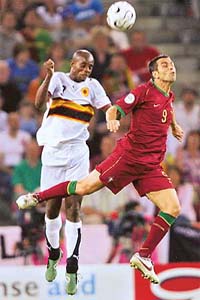 Portuguese forward Pauleta and Angolan forward Akwa jump for the ball during a Group D match in Cologne