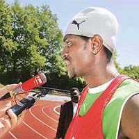 Togolese forward Emmanuel Adebayor answers questions from media representatives after a training session in Wangen