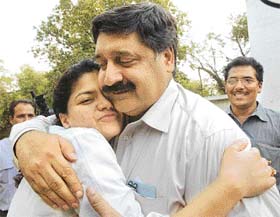 The late BJP leader Pramod Mahajan�s secretary, Harish Sharma, hugs Mahajan�s daughter Poonam after the hearing of Rahul Mahajan�s release on bail in New Delhi