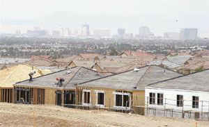 Hotel-casinos on the Las Vegas Strip are seen behind an area of new home construction in Las Vegas. After years of skyrocketing real estate prices, Las Vegas� housing market hit a new record for unsold homes and condominiums in May 2006, and developers are beginning to drop prices as the supply of new houses exceeds the demand. Despite the glut of housing, construction in Las Vegas continues unabated as thousands of new residents continue to flock to the city for work.
