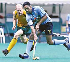 Australia�s Rober Hammond attempts to wrestle the ball from Tejbir Singh during the Sultan Azlan Shah hockey tournament in Kuala Lumpur