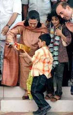 Congress President Sonia Gandhi presents a gift to a bus passenger from occupied Kashmir after flagging off the Poonch-Rawalkot bus service at Chakan-da-Bagh in Poonch district of J&K on Tuesday