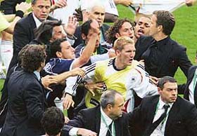 Argentinian midfielder Maxi Rodriguez (third from right) punches German midfielder Bastian Schweinsteiger (centre) after fighting broke out following the end of the quarterfinal match between Germany and Argentina in Berlin