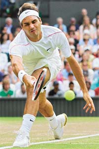 Roger Federer of Switzerland returns a shot to Mario Ancic of Croatia during their quarterfinal match on the Wimbledon�s Centre Court