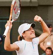 Justine Henin-Hardenne rejoices after winning her semifinal against Kim Clijsters at Wimbledon in London on Thursday. Henin-Hardenne won 6-4, 7-6.