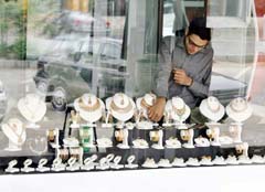  Pakistani shopkeeper arranges jewellery at a shop in Islamabad on Friday. Gold prices on the Hong Kong 