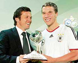 German football legend Lothar Matthaus hands over the FIFA Best Young Player award to Germany�s star striker Lukas Podolski