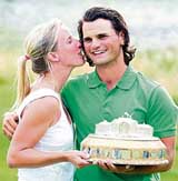 Johan Edfors of Sweden celebrates with his girlfriend Cecilia Berquist after winning the Scottish Open golf championship at Loch Lomond in Scotland on Sunday