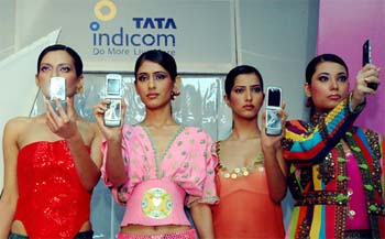 Models display new CDMA handsets jointly launched by Tata Indicom and Motorola in New Delhi on Wednesday. Motorola and Tata Teleservices Ltd. today announced a partnership to bring in style to CDMA mobile phones for Indian consumers. Through this partnership, Motorola and Tata Indicom will jointly market, distribute and support the Motorazr V3c, costing Rs 14,500, across the country.