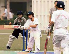 Chinese students play cricket during China�s first national cricket championship at Tsinghua University in Beijing on Monday. Although cricket was brought to China by the British in 1858, the game was never taken up by the locals and a few expatriate tournaments did not exist until the turn of the century.