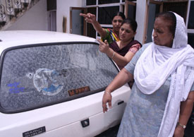 Family members of Balkar Singh show bullet marks which hit the rear window of his Maruti car when a brother of an MLA allegedly opened fire in an inebriated state in Rajasansi on Friday. 
