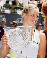 Belgium�s Kim Clijsters holds the trophy after beating Switzerland�s Patty Schnyder in the final of the Bank of the West tennis tournament in Stanford, California, on Sunday. Clijsters won 6-4, 6-2.