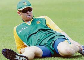 South African cricketer Shaun Pollock stretches during a practice session at the Sinhalese Sports Club in Colombo