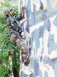 Harbhajan Singh climbs a wall during a special physical training programme for the cricket team in Bangalore