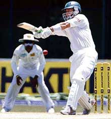 South Africa�s Herschelle Gibbs plays a shot as Sri Lankan captain Mahela Jayawardene looks on during the third day of the second Test in Colombo on Sunday.