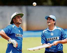 Sachin Tendulkar tosses the ball as Virender Sehwag looks on during a training session at the Chinnaswamy stadium in Bangalore on Monday.