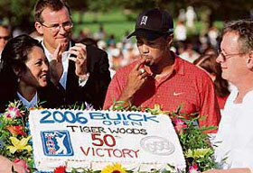 Tiger Woods celebrates his Buick Open victory (and his 50th PGA Tour title) at Warwick Hills Golf & Country Club in Grand Blanc, Michigan, on Sunday. 