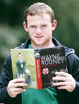 England football star Wayne Rooney poses with his book �My story so far� in Manchester on Thursday