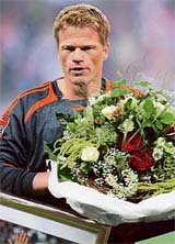 Munich�s goalkeeper Oliver Kahn carries a bouquet that he received for his 500th Bundesliga appearance ahead of the opening match of the Bundesliga season against Dortmund in Munich.