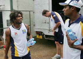 Sri Lanka�s Malinga Bandara talks to team-mate Dilhara Fernando after an indoor practice session in Colombo