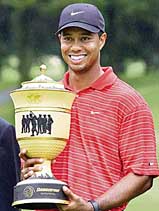Tiger Woods of the USA holds the Gary Player trophy after winning the WGC Bridgestone Invitational golf tournament at the Firestone Country Club in Akron, Ohio, on Sunday. 