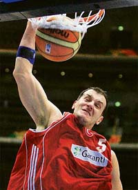 Turkey�s Ermal Kurtoglu scores against Lithuania during a classification match at the World Basketball Championship in Saitama, Japan