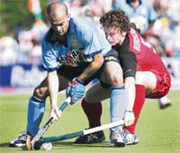 Germany�s Sebastian Biederlack (right) fights for the ball with Viren Rasquinha during their World Cup match at the Warsteiner Hockey Park Stadium in Monchengladbach on Wednesday.