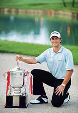 Australia�s Adam Scott poses for photographers after winning the Singapore Open golf tournament