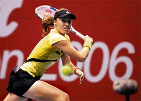 Martina Hingis returns a shot to Sania Mirza during a semifinal match of the Sunfeast Open in Kolkata