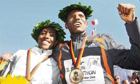Ethiopians Haile Gebrselassie and Gete Wami  pose on the podium of the 33rd Berlin City Marathon on Sunday
