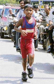 Mrutunjaya Mandal Akash runs along the eastern express in Mumbai on Sunday
