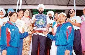 Chief Parliamentary Secretary Rana Gurmit Singh Sodhi presents the overall trophy to Jalandhar girls in Ropar