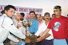 Punjab Cricket Club captain Reetinder Singh Sodhi and his team-mate Dinesh Mongia receive the All-India JP Atray Cricket Tournament trophy from Haryana Governor AR Kidwai at the Sector 3 Cricket Stadium in Panchkula