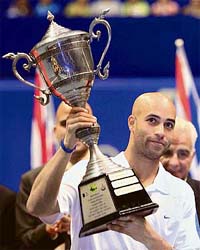 James Blake of the USA lifts the trophy after winning the Thailand Open tennis tournament in Bangkok