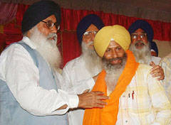 Mr Parkash Singh Badal, president of the SAD, presents a siropa to Mr Satpal Singh Wadali, district president of the SAD (Longowal), after Mr Wadali joined the SAD in Amritsar