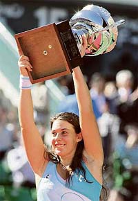 France�s Marion Bartoli holds the trophy after defeating Japan�s Aiko Nakamura 2-6, 6-2, 6-2 in the final of the Japan Open tennis championship in Tokyo