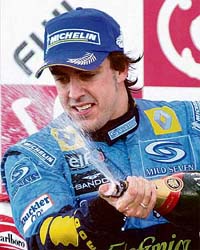 Renault Formula One driver Fernando Alonso of Spain splashes champagne after winning the Japanese Grand Prix in Suzuka