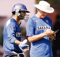 Rahul Dravid (left) gestures as he talks with coach Greg Chappell during a training session at the Swai Mansingh Stadium in Jaipur