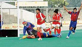 Mumbai�s Vikas Pillai collides with the Karanataka goalkeeper as he pushes the ball into the goal during the 62nd National Hockey Championship at Olympian Surjit Hockey Stadium in Jalandhar on Tuesday