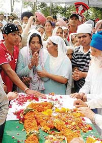 The widow, two sons and father of slain Orissa DIG Jaswinder Singh are inconsolable as his body is taken for the funeral in Bodal village, near Dasuya
