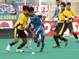 Pakistan�s Shadman Club and SAI players fight for the ball during a match at the 23rd Indian Oil Surjit Hockey Tournament at the Olympian Surjit Hockey Stadium in Jalandhar on Thursday